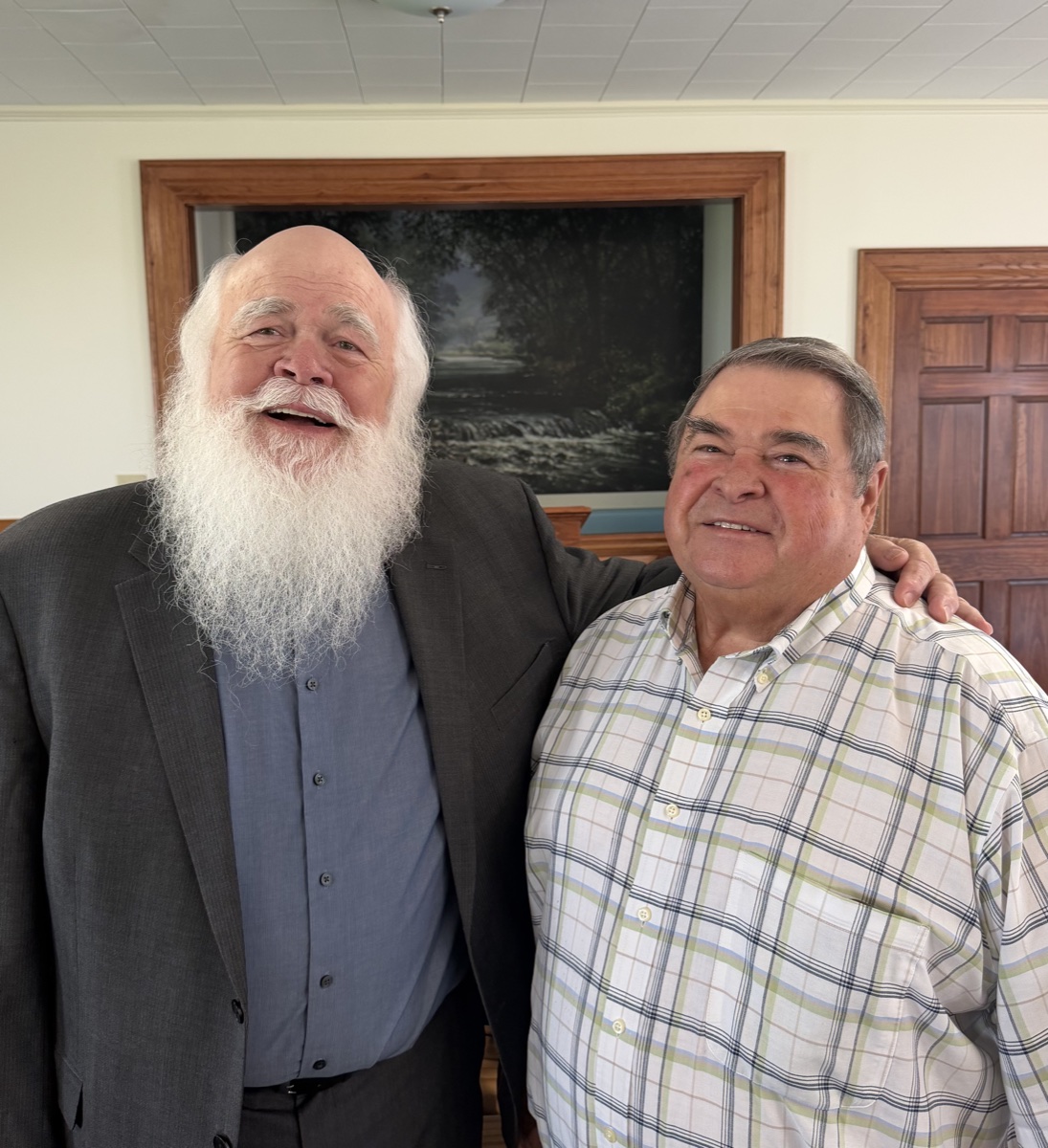 The two elders of the Carthage Church of Christ standing together inside the church building